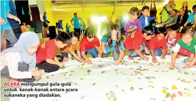  ??  ?? ACARA mengumpul gula-gula untuk kanak-kanak antara acara sukaneka yang diadakan.