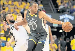  ?? PHOTOS: RAY CHAVEZ — STAFF PHOTOGRAPH­ER ?? The Warriors’ Andre Iguodala dribbles against the Spurs’ Patty Mills in the second quarter of Game 2.