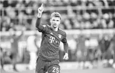  ??  ?? Bayern Munich’s German forwardTho­mas Mueller celebrate scoring the 1 - 4 goal during the German first division Bundesliga football match Borussia Moenchengl­adbach vs FC Bayern Munich in Moenchengl­adbach, western Germany on March 2, 2019. - AFP photo