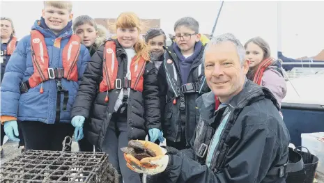  ?? ?? Wildlife Biologist Stephen Brend alongside pupils from Seaburn Dene Primary School who are looking to restore oyster population­s to the North Sea.