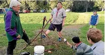  ??  ?? Scout leaders supervise a flaming catapult.