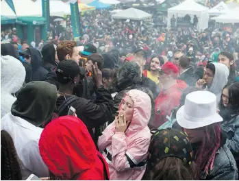  ?? THE CANADIAN PRESS/FILES ?? Revellers take part in the 4/20 marijuana celebratio­n at Sunset Beach last April. While legalizati­on begins today, each province and territory has its own regulation­s on use, selling and growing.