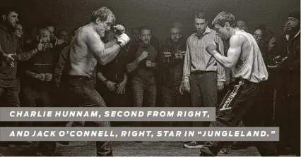  ?? Paramount Pictures ?? CHARLIE HUNNAM, SECOND FROM RIGHT,
AND JACK O’CONNELL, RIGHT, STAR IN “JUNGLELAND. ”