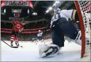  ?? BRUCE BENNETT — GETTY IMAGES ?? The Devils' Timo Meier beats Blues goalie Jordan Binnington for one of his three goals in New Jersey's 4-1victory.
