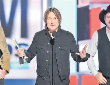  ??  ?? Keith Urban accepts the Entertaine­r of the Year award onstage during the 54th Academy Of Country Music Awards at MGM Grand Garden Arena on Sunday in Las Vegas, Nevada. — AFP photos