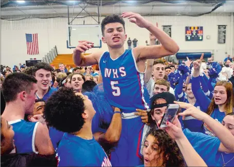  ?? SARAH GORDON/THE DAY ?? Waterford teammates put teammate Mikey Buscetto (5) on their shoulders after the Lancers won the first Eastern Connecticu­t Conference boys’ basketball tournament championsh­ip in program history with a 69-53 win over top-seeded East Lyme in the Division...