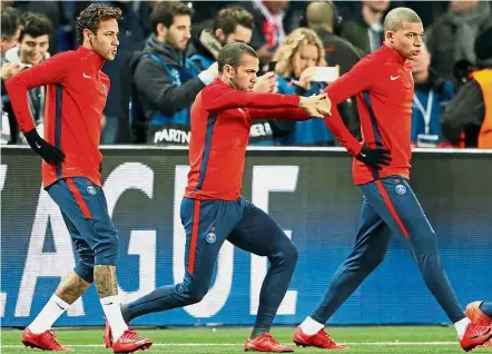  ??  ?? Expensive stars: PSG’s (from left) Neymar, Dani Alves and Kylian Mbappe warming up ahead of their Champions League match against Celtic at the Parc des Princes Stadium in Paris last Nov 22. — Reuters