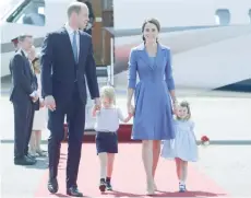  ?? — AFP ?? Prince William and his wife Kate with their children Prince George and Princess Charlotte arrive at the airport in Berlin on Wednesday.