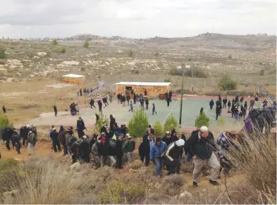  ??  ?? DOZENS OF SUPPORTERS make their way to the Amona outpost yesterday to express solidarity with residents.