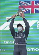  ?? EMILIO MORENATTI/POOL VIA AP ?? Mercedes driver Lewis Hamilton lifts his trophy after winning the Spanish Formula One Grand Prix on Sunday.