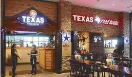  ??  ?? Texas Roadhouse, known for its hand-cut steaks and fall-off-thebone ribs, opens its first branch in the country at Uptown Mall.