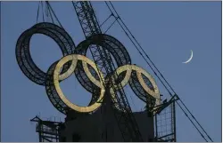  ?? NG HAN GUAN — THE ASSOCIATED PRESS FILE ?? A worker labors to assemble the Olympic Rings onto of a tower on the outskirts of Beijing earlier this month. The Beijing Winter Olympics are fraught with potential hazards for major sponsors, who are trying to remain quiet about China’s human rights record while protecting at least $1billion they’ve paid to the IOC.