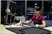  ?? PHOTOS BY ALYSSA POINTER/ALYSSA.POINTER@AJC.COM ?? Lund employee Tuong Tran creates a car mat in Lawrencevi­lle. Lund’s workforce is more diverse — both demographi­cally and generation­ally — than it might have been in decades past.