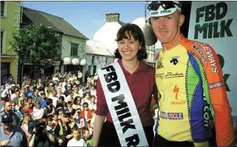  ?? Photo by John Reidy ?? Flashback to 2001: Listowel cyclist Eugene Moriarty of the Meath Cycleways Team is congratula­ted by FBD Milk RÁS Queen, Monica O’Sullivan from Currow on his third place finish into Castleisla­nd.