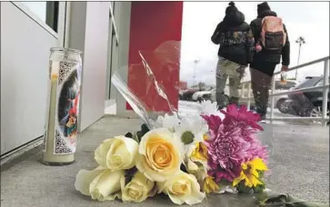  ?? Genaro Molina Los Angeles Times ?? A CANDLE and flowers are left for Valentina Orellana-Peralta at the Burlington store where she was killed.