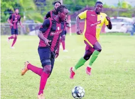  ?? FILE PHOTOS ?? Kemal Malcolm of Arnett Gardens moves away from Humble Lion’s Gregory Lewis during their RSPL encounter at Effortvill­e on December 29, 2019.