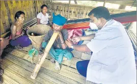 ??  ?? A Reang (Bru) woman receives the first dose of the vaccine against Covid-19, in Agartala.
