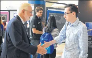  ?? DAVID JALA/CAPE BRETON POST ?? Breton Education Centre Grade12 student Joshua Cameron, right, said it was a pleasure to meet Sydney native and astrophysi­cist Art McDonald, who was awarded a 2015 Nobel Prize in Physics for his work on neutrino oscillatio­n, at the Power of Ideas...