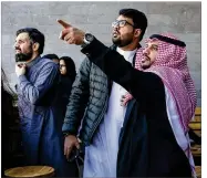  ?? TASNEEM ALSULTAN / THE NEW YORK TIMES ?? Customers at a coffee shop Tuesday in Riyadh, Saudi Arabia, look at a cloud of smoke that followed a loud boom. The Saudi government said it had intercepte­d a Houthi missile.