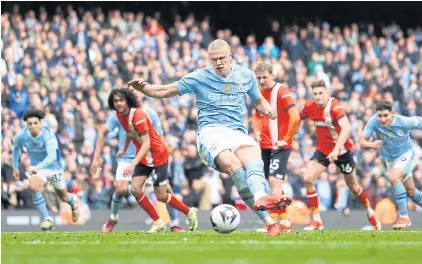  ?? REUTERS ?? Manchester City’s Erling Braut Haaland scores their third goal from the penalty spot during the Premier League match against Luton on Saturday.