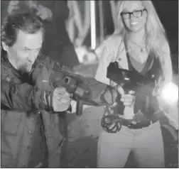  ??  ?? Stephen Mchattie and Emilie Ullerup play well- armed zombie hunters in A Little Bit Zombie.