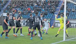  ?? ?? Despite being surrounded by defenders, Craig Wighton heads home Dunfermlin­e’s winner at Falkirk