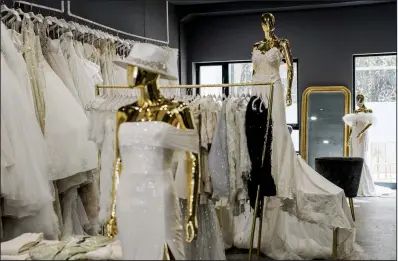  ?? (The New York Times/Gabriela Bhaskar) ?? These dresses are seen at Pantora Bridal in New York in August. After postponing their weddings for months, brides are storming ateliers looking for gowns in a hurry.