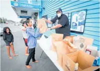  ??  ?? A Te Awa local receiving free food from Jazz Singh, of Creagh St Dairy, during the 2020 lockdown.