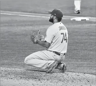  ??  ?? KENLEY JANSEN drops to his knees after Phillips’ single, the second he gave up in the ninth inning. Jansen also walked a batter, who came around to score the winning run on an error.