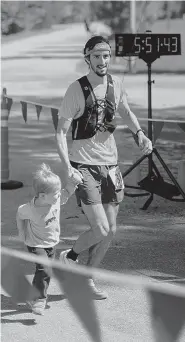  ?? CONTRIBUTE­D PHOTO BY HANNAH DAVIS ?? Nathan Sexton and his 2-year-old son, Jack, enjoy the day during this month’s StumpJump 50K trail run competitio­n.