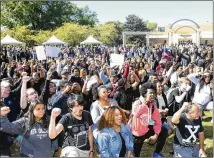  ?? REBECCA BREYER ?? Protesters “take a knee” Thursday at Kennesaw State University in support of the KSU cheerleade­rs who knelt during the national anthem after Sam Olens became KSU president.