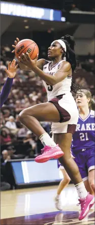  ?? David J. Phillip / Associated Press ?? Texas A&M’s Anriel Howard, center, goes up for a shot against Drake on March 16 in College Station, Texas.