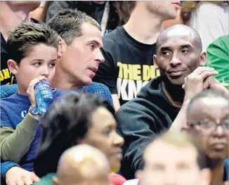  ?? Harry How Getty Images ?? ROB PELINKA, left, chatting with longtime client Kobe Bryant at an NCAA tournament game last year, is expected to be named the Lakers’ new general manager.