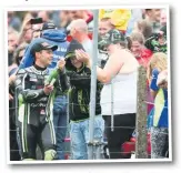  ??  ?? Haslam sprays happy(ish) fans with bubbly