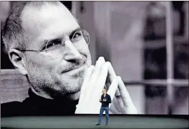  ?? / AP-Marcio Jose Sanchez ?? Former Apple co-founder and CEO Steve Jobs projected in the background, Apple CEO Tim Cook kicks off the event for a new product announceme­nt at the Steve Jobs Theater on the new Apple campus in Cupertino, Calif. Apple has become the world’s first...