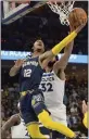  ?? ?? Grizzlies guard Ja
Morant shoots against Timberwolv­es center KarlAnthon­y Towns in the first half during Game 5 of a playoff series Tuesday.