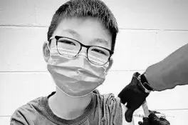  ?? RICHARD CHUNG 2020 ?? Caleb Chung is given his first dose of the Pfizer vaccine or placebo Dec. 22 as a trial participan­t for kids ages 12 to 15 at Duke University Health System in North Carolina.