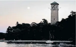  ??  ?? An almost full moon rises over the Dingle Tower in Sir Sandford Fleming Park in Halifax, Aug. 28, 2015. (Adrien Veczan/Halifax Herald)