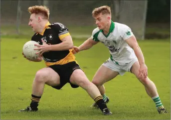  ??  ?? Realt na Mara’s Dylan Sweeney in action against Seamus Carroll of Crossabeg-Ballymurn.