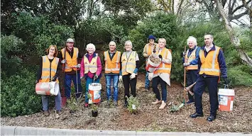  ?? ?? Members of the stationeer­s program work hard to keep Drouin’s Railway Station’s garden neat and tidy. (from left) Kay Stephenson, Noel Ward, Aileen Ward, John Vitale, Julia Hurst, Mary Junor, V/Line community engagement officer Jacinta Addamo, Mildred Lyon, and V/Line service manager Theo Politakis.