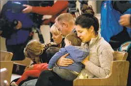  ??  ?? KRISTY COLLINS hugs her son Andrew at the vigil. The list of people missing after the fire is shifting. Some names are repeated; others may be safe elsewhere.