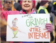  ?? CAROLYN KASTER/ASSOCIATED PRESS ?? Diane Tepfer holds a sign critical of FCC Chairman Ajit Pai during a protest in Washington of the repeal of “net neutrality” rules for internet service providers.