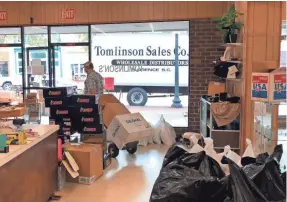  ?? JEFFREY COLLINS/AP ?? Employees at Tomlinson Department Store remove merchandis­e in case of flooding in Georgetown, S.C., on Monday.