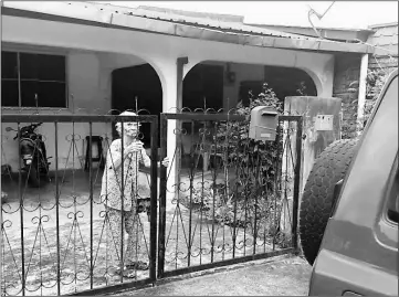  ??  ?? Liu opens the gate to the family’s low-cost house.