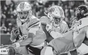  ??  ?? Justin McMillan tossed three third-quarter TD passes to lift Tulane in the Armed Forces Bowl. Icon Sportswire via Getty Images