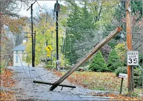  ?? MEDIANEWS GROUP FILE PHOTO ?? A utility pole snapped and wires are tangled on the ground on Buckwalter Road near Ellis Woods Road in East Coventry in the aftermath of high winds from Hurricane Sandy.