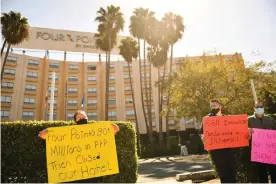  ??  ?? Laid-off employees and workers with Unite Here 11 protest outside the closed Four Points by Sheraton LAX hotel. Photograph: Patrick T Fallon/AFP/Getty Images