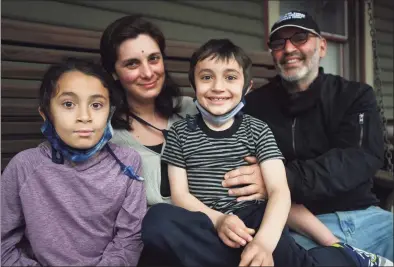  ?? Brian A. Pounds / Hearst Connecticu­t Media ?? Sarah Miller and Lee Cruz, of New Haven, enrolled their children, Pablo, 10, left, and Mateo, 6, in a Moderna COVID-19 vaccine trial at Yale University in New Haven. The family is seen here on Wednesday.