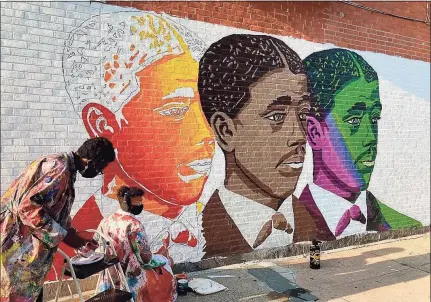  ?? Contribute­d photos ?? Artist Kwadwo Adae and his son Kwasi Adae work on the elder Adae’s latest city mural depicting Yale University graduate Edward Alexander Bouchet, the first African American doctoral recipient in the United States.