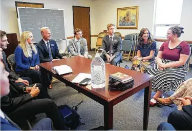  ?? Photos by Elizabeth Conley / Staff photograph­er ?? Mission President Matthew Richards and his wife, Debby, center left, meet with missionari­es at the Church of Jesus Christ of Latter-day Saints, Texas Houston South Mission in Sugar Land.